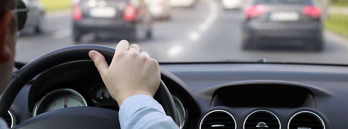 Hombre conduciendo en una carretera con tráfico